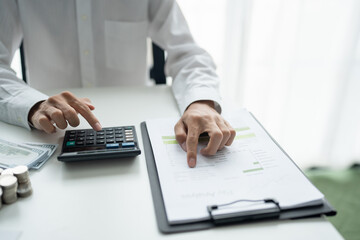 Businessman checking bills taxes bank account balance and calculating annual financial statements...