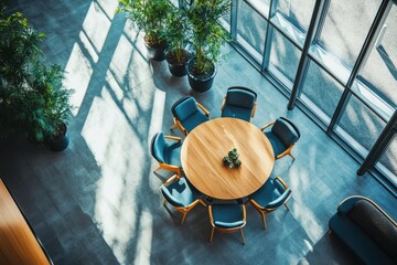 Overhead view of round table with blue chairs and potted plants