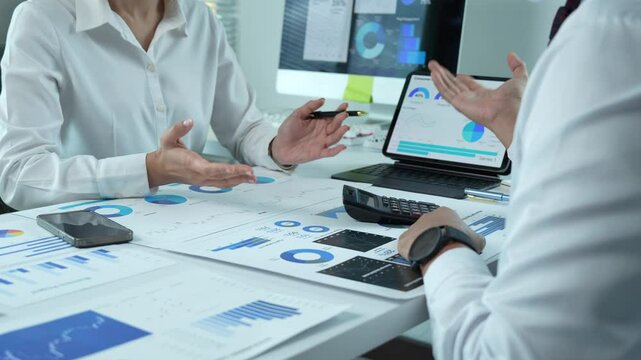 Business people analyzing financial charts and data on desk - Powered by Adobe