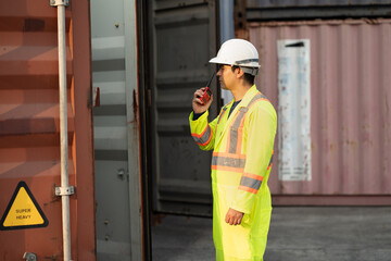 Caucasian worker use walkie talkie working with checking container at container site	