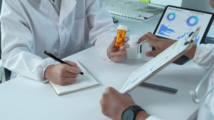 Medical professionals analyzing pharmaceutical data and medication
