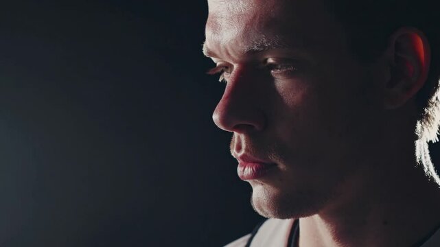 Focused contemplation: A close-up portrait captures a focused individual in deep contemplation, the dramatic lighting heightening the introspection and inner thoughts.