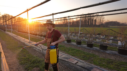 Male gardener working in a blueberries organic farm.
