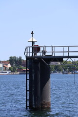 Metal Structure Over Water with Urban Background
