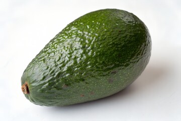Single ripe hass avocado on white background