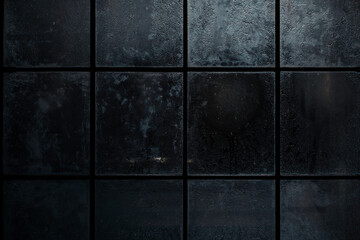 A dramatic close-up of a raindrop on a dark, moody surface