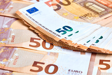 Banknotes 50 euro. Stack of new 2017 fifty Euro banknotes lays on a haphazardly heap or pile of euro bills close up.