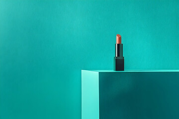 A lipstick on a teal colored surface.