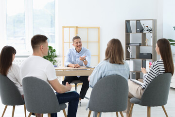 Group of people having meeting during life coaching class indoors