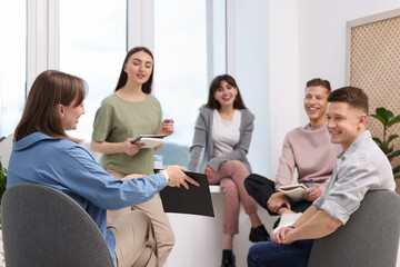 Group of people having meeting during life coaching class indoors