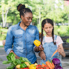 Happy black farmer mother and daughter on vegetable farm for agriculture, business growth and...