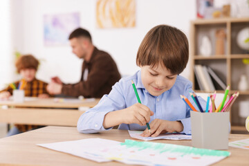 Fototapeta premium Kids with teacher at painting lesson indoors, selective focus. Learning to draw