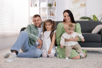 Happy parents and their kids together at home