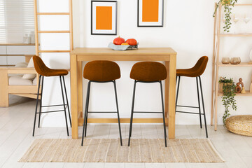 Dining table and orange chairs in room. Interior design