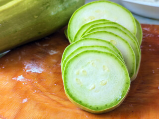 Slices of zucchini on a cutting board. Selective focus.