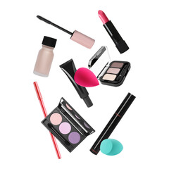Different makeup products flying against white background