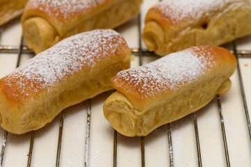 Golden homemade Parker House rolls resting on a wire rack after baking, fresh from the oven and ready to serve.