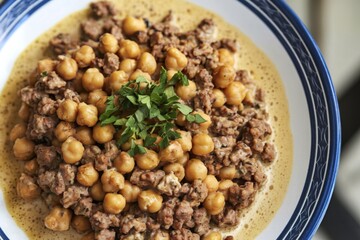 a plate with fried chickpeas and ground meat in a creamy sauce