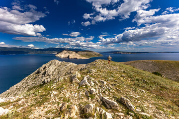 Climbing the Bag peak on the island of KRK, a view of the panorama of the city of Baska, sharp rocks,