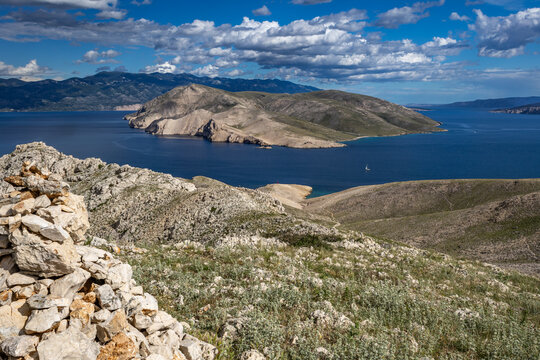 Climbing the Bag peak on the island of KRK, a view of the panorama of the city of Baska, sharp rocks,