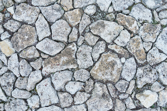 Background of irregular and rough pebbles. Top view of stones texture