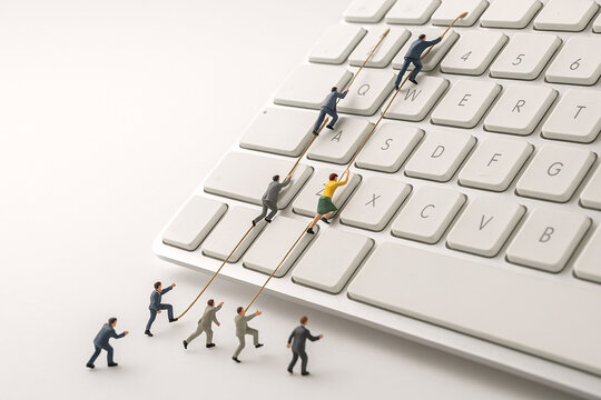 A group of people are climbing a keyboard
