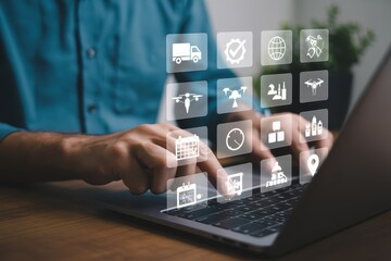 A person interacts with a laptop displaying a variety of digital icons.