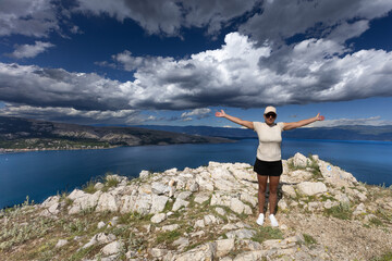 Obraz premium Climbing the Bag peak on the island of KRK, a view of the panorama of the city of Baska, sharp rocks,