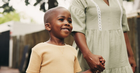 Happy, black family and child walking with mom in neighborhood for travel, childhood or bonding. Kid, son or holding hands with mother, parent or guardian for outdoor safety or security together
