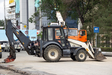 road construction site with a tractor with jackhammer