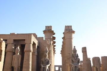 Ancient Pharaoh Statue in Front of Luxor Temple Columns