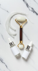 Facial Roller and Collagen Threads with Serum Bottles on Marble Background