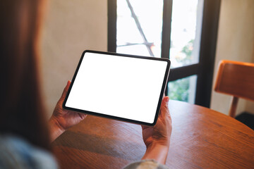 Mockup image of a woman holding digital tablet with blank white desktop screen