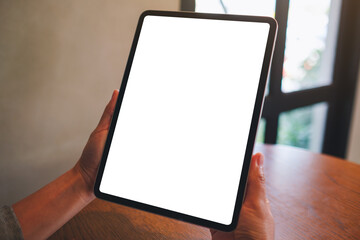 Mockup image of a woman holding digital tablet with blank white desktop screen