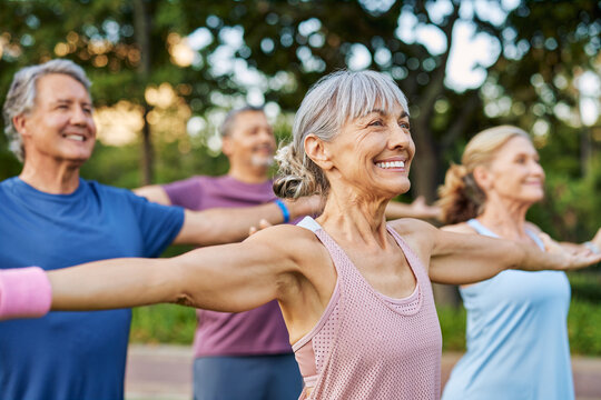 Multiethnic mature group of people practicing stretching at park - Powered by Adobe