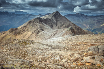 Alpine boundless panorama with peaks under a dramatic sky near the Italian Austrian border, Vallelunga, Alto Adige, Italy