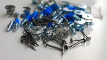 Close-up of many furniture fittings on a white surface