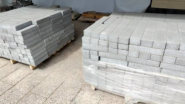 Pallet with paving slabs at a construction site. Construction materials ready for use