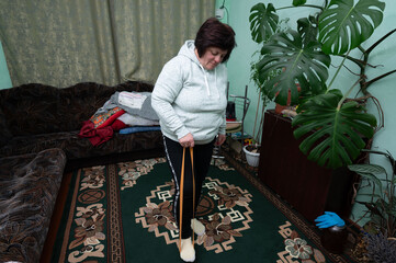 Woman engages in home exercise routine using elastic band, creating a healthy lifestyle in a cozy...