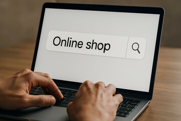 Close-up of a person's hands typing a search query on a laptop for an online store