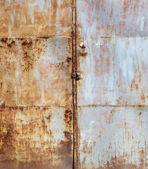 The image is of a rusty metal door with a lock on it