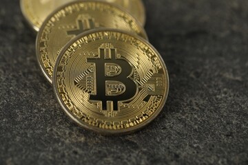 Cryptocurrency. Bitcoins on grey table, closeup view