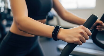 Woman exercising with fitness tracker in gym. Healthy lifestyle.