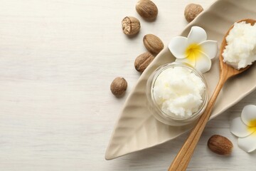 Natural shea butter on white wooden table, flat lay. Space for text