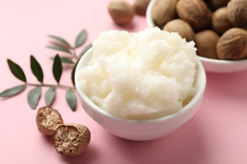 Natural shea butter on pink background, closeup