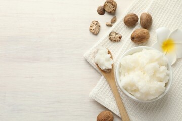 Natural shea butter on white wooden table, flat lay. Space for text