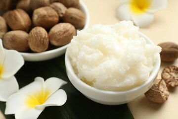 Natural shea butter on beige background, closeup