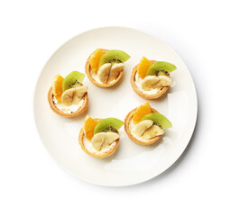 Tartlets with fruits isolated on white, top view. Delicious dessert