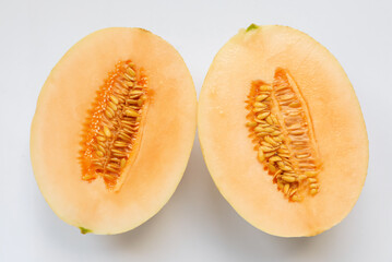 Halves of juicy melon on white background, top view