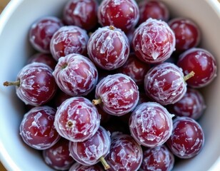 frozen grapes in a white bowl, vibrant purple color and frosty texture, served as a natural sweet snack in hot summer weather.